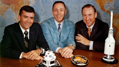 In this April 10, 1970 photo made available by NASA, Apollo 13 astronauts, from left, Fred Haise, Jack Swigert and Jim Lovell gather for a photo on the day before launch.