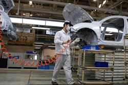In this April 8, 2020, file photo, workers assemble cars at the Dongfeng Honda Automobile Co., Ltd factory in Wuhan in central China's Hubei province. China's auto sales sank 48.4% in March from a year ago as the economy reeled from the coronavirus, according to an industry group, adding to strains for the struggling industry in its biggest global market.