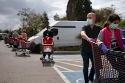 Customers wear face masks as they line up to enter a supermarket keeping social distancing following the government's measures to help stop the spread of the coronavirus, in Tel Aviv, Israel, Tuesday, April 7, 2020. Israeli Prime Minister Benjamin Netanyahu announced Monday a complete lockdown over the upcoming Passover holiday to control the country's coronavirus outbreak, but offered citizens some hope by saying he expects to lift widespread restrictions after the week-long festival.