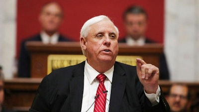 In a Wednesday, Jan. 8, 2020 file photo, West Virginia Governor Jim Justice delivers his annual State of the State address in the House Chambers at the state capitol, in Charleston, W.Va. Gov. Justice said during a media briefing Wednesday, March 4, 2020, at the state Capitol in Charleston that state residents should live their normal lives and not cancel travel plans despite the emerging threat of the new coronavirus. There are no known cases of the virus thus far in West Virginia.