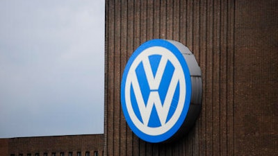 A security guard stands on the roof of the Volkswagen old power plant and monitors the area during the company's annual press conference in Wolfsburg, Germany, Thursday, April 28, 2016.