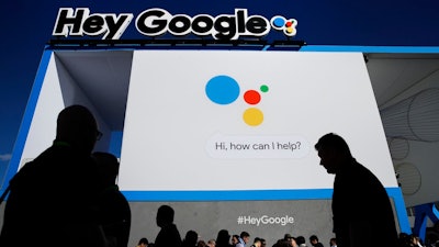 People wait in line to enter the Google booth at CES International, Wednesday, Jan. 10, 2018, in Las Vegas.