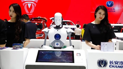 In this April 26, 2018, file photo, a robot assist receptionist is seen at the booth of a Chinese automaker during the China Auto 2018 show in Beijing, China. Under President Xi Jinping, a program known as 'Made in China 2025' aims to make China a tech superpower by advancing development of industries that in addition to semiconductors includes artificial intelligence, pharmaceuticals and electric vehicles.