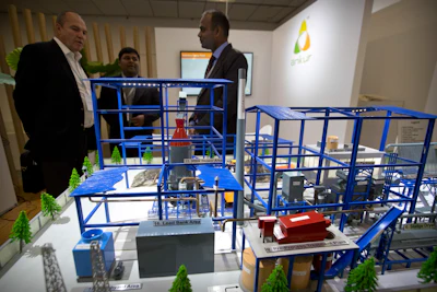 Visitors look at a display of a self-contained sewage treatment facility the Reinvented Toilet Expo in Beijing, Tuesday, Nov. 6, 2018. With a jar of human feces on a podium next to him, billionaire philanthropist Bill Gates has kicked off a 'Reinvented Toilet' Expo in China. Gates said Tuesday that the technologies on display at the three-day expo in Beijing represent the most significant advances in sanitation in nearly 200 years.