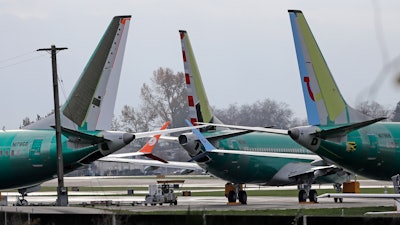 In this Nov. 14, 2018, file photo Boeing 737 MAX 8 planes are parked near Boeing Co.'s 737 assembly facility in Renton, Wash. Investigators were rushing to the scene of a devastating plane crash in Ethiopia on Sunday, March 10, 2019, an accident that could renew safety questions about the newest version of Boeing's popular 737 airliner.