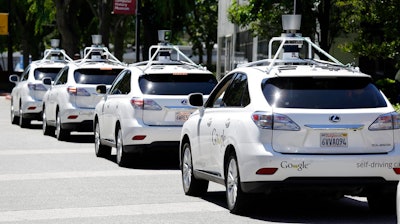 A row of driverless SUVs being tested as part of Google's technology initiative.