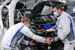 Employees of Volkswagen work with face masks.