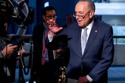 In this March 20, 2020, file photo Senate Minority Leader Sen. Chuck Schumer of N.Y., speaks to reporters as he arrives for a meeting to discuss the coronavirus relief bill on Capitol Hill Washington. The Trump administration and Congress are nearing an agreement as early as Sunday, April 19, on a $400-plus billion aid package to boost a small-business loan program that has run out of money and add funds for hospitals and COVID-19 testing.