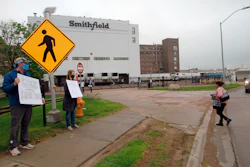 Residents cheered and held thank you signs to greet employees of a Smithfield pork processing plant as they begin their shift on Wednesday, May 20 in Sioux Falls, SD.