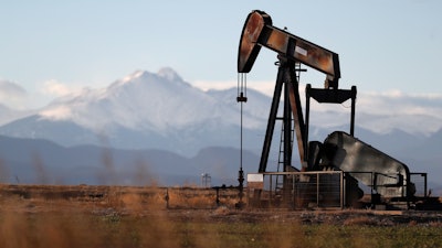 A pump jack over an oil well along Interstate 25 near Dacono, Colo.