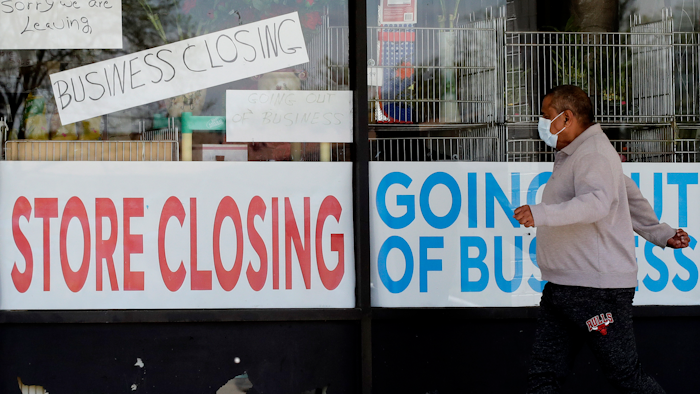 Signs at a closed store in Niles, Ill., May 21, 2020.