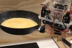 Robot arm preparing an omelette.