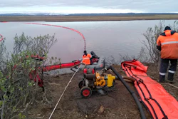 Rescuers work to prevent the spread of an oil spill outside Norilsk, Russia, June 2, 2020.