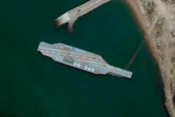 In this Sunday, June 7, 2020 satellite photo provided by Maxar Technologies, a fake aircraft carrier is seen off the coast of Bandar Abbas, Iran.