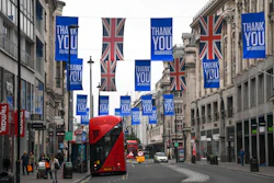 Union flags and support messages are seen in the shopping street, Oxford Street, ahead of the reopening of the non-essential businesses on Monday, June 15, as some of the coronavirus lockdown measures are eased, in London, Friday, June 12, 2020. The British economy shrank by a colossal 20.4% in April, the first full month that the country was in its coronavirus lockdown, official figures showed Friday.