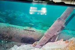 Shot from a television screen shows damage to an anchor support.