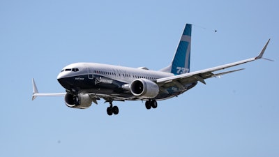 A Boeing 737 MAX jet heads to a landing at Boeing Field following a test flight.