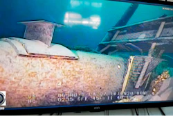 This June 2020 file photo, shot from a television screen provided by the Michigan Department of Environment, Great Lakes, and Energy shows damage to anchor support EP-17-1 on the east leg of the Enbridge Line 5 pipeline within the Straits of Mackinac in Michigan. Michigan Gov. Gretchen Whitmer criticized Enbridge Inc. on Wednesday, July 22, 2020 for what she described as the company's refusal to make an airtight pledge that it would pay for any damages caused by an oil spill from its pipeline beneath a Great Lakes waterway.