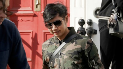 Vorayuth 'Boss' Yoovidhya walks to get in a car as he leaves a house in London.