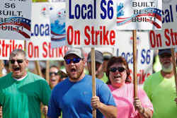 Striking Bath Iron Works shipbuilders march in solidarity.