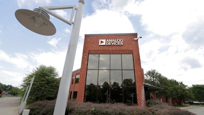 Clouds are reflected in the headquarters of Analog Devices, Inc., Monday, July 13, 2020, in Norwood, Mass. Computer chip maker Analog Devices is buying Maxim Integrated in an all-stock deal that will create a company worth about $68 billion, and strengthens its position in the analog semiconductor sector.