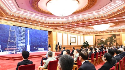 In this photo released by Xinhua News Agency, officials attend the completion and commissioning ceremony for the Beidou Navigation Satellite System (BDS-3) at the Great Hall of the People in Beijing Friday, July 31, 2020. China is celebrating the completion of its BeiDou Navigation Satellite System that could rival the U.S. Global Positioning System and significantly boost China's security and geopolitical clout.