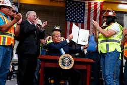 In this April 10, 2019, file photo, President Donald Trump holds up an executive order on energy and infrastructure after signing it at the International Union of Operating Engineers International Training and Education Center in Crosby, Texas. Attorneys general in 20 states and the District of Columbia sued the Trump administration on Tuesday, July 21, 2020, alleging that new federal rules undermine their ability to protect rivers, lakes and streams within their borders. President Trump in April 2019 issued an executive order directing the change that critics said could make it harder for states to block pipelines and other projects over concerns that they could impair water quality.