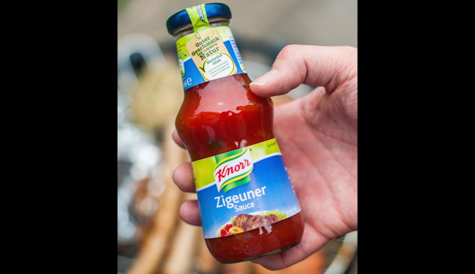 In this 2014 photo, a man holds a bottle of &apos;gypsy sauce&apos; from the manufacturer Knorr in his hand in Berlin, Germany.