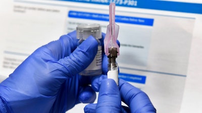 A nurse prepares a shot in a study of a possible COVID-19 vaccine in Binghamton, N.Y., July 27, 2020.
