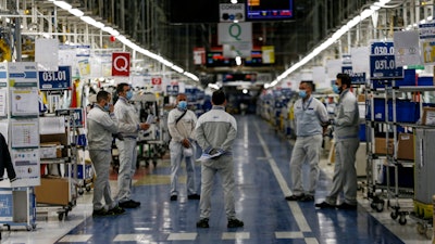 Managers inform small groups of workers about new safety devices and measures taken at the Fiat Chrysler Automobiles plants.