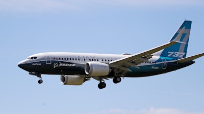 A Boeing 737 MAX jet heads to a landing