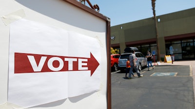 Voters walk to a polling station to cast votes in Arizona's primary, Aug. 4, 2020, Chandler, Ariz.