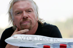 Richard Branson attends a news conference.
