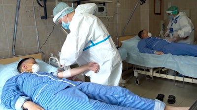 Medical workers prepare to draw blood from volunteers participating in a trial of a coronavirus vaccine at the Budenko Main Military Hospital outside Moscow, July 15, 2020.