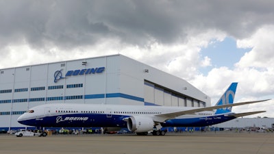 Boeing employees stand near the new Boeing 787-10 at the company's facility in North Charleston, S.C.