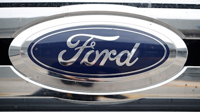 The company logo shines at a Ford dealership in Littleton, Colo.