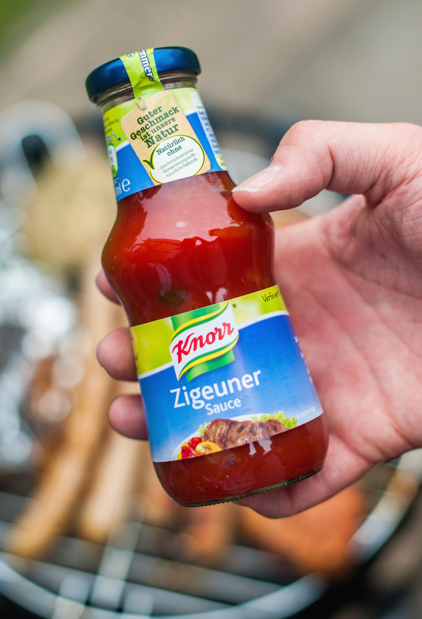 In this 2014 photo, a man holds a bottle of 'gypsy sauce' from the manufacturer Knorr in his hand in Berlin, Germany.