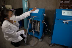 Fanny Alvarado Chavez, head of the Biomedical Engineering department at the National Institute of Medical Science and Nutrition, with a VSZ-20-2 ventilator, Mexico City, Aug. 17, 2020.