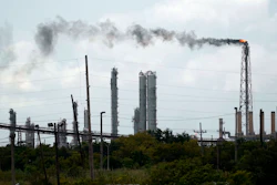 Winds blow the smoke from a refinery.