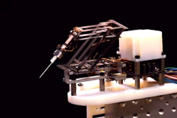 Mini-RCM controlled by three linear actuators that allow it to move in multiple dimensions and help correct hand tremors and other disturbances during teleoperation.