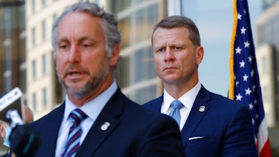 Acting Director of U.S. Immigration and Customs Enforcement Matt Albence comments Thursday, Aug. 6, 2020, in Jackson, Miss., after the announcement of the indictments of four executives from two Mississippi poultry processing plants on federal charges tied to one of the largest workplace immigration raids in the U.S. in the past decade. Their announcement happened a day before the one-year anniversary of the raids in which 680 people were arrested at seven poultry plants in central Mississippi. U.S. Attorney Mike Hurst listens in rear.