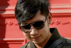 In this April 5, 2017, file photo, Vorayuth 'Boss' Yoovidhya, whose grandfather co-founded energy drink company Red Bull, walks to get in a car as he leaves a house in London. A Thai court on Tuesday, Aug. 25, 2020 issued a new arrest warrant for an heir to the Red Bull energy drink fortune, a month after news that prosecutors had dropped a long-standing charge against him caused widespread uproar and anger.