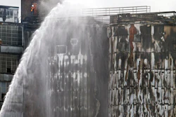 St. Bernard firefighters battle a 3-alarm fire after silos caught fire at the century-old Domino Sugar Refinery in Arabi, La., Thursday, Aug. 27, 2020.