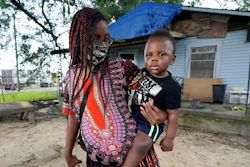 Fakisha Fenderson and her son Tyler stand in the front yard of her parent's home in Laurel, Miss.
