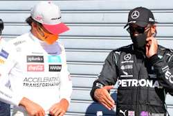 Mercedes driver Lewis Hamilton, right, talks with Mclaren driver Carlos Sainz at the Monza racetrack in Monza, Italy, Sept. 5, 2020.