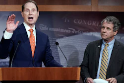 In this Jan. 15, 2020 photo, Senate Finance Committee ranking member Ron Wyden, D-Ore., speaks during a news conference at the Capitol in Washington, about a U.S. China trade agreement, accompanied by Sen. Sherrod Brown, D-Ohio, right.