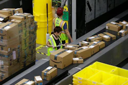 In this Feb. 9, 2018, file photo packages move down a conveyor system were they are directed to the proper shipping area at the new Amazon Fulfillment Center in Sacramento, Calif. Amazon said Monday, Sept. 14, 2020, that it will be hiring another 100,000 people to keep up with a surge of online orders. The company said the new hires will help pack, ship or sort orders, working in part-time and full-time roles. Amazon said the jobs are not related to its typical holiday hiring.