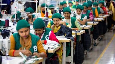 In this April 19, 2018 file photo, trainees work at Snowtex garment factory in Dhamrai, near Dhaka, Bangladesh. After months of decline in exports of its garment products, Bangladesh’s economy is showing signs of recovery. The Asian Development Bank in a new report said Tuesday, Sept. 15, 2020, the country's economy's comeback was encouraging and it is expected to grow by 6.8 percent in the current fiscal year ending in June if this recovery sustains.