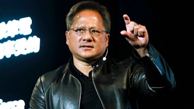 In this Tuesday, May 30, 2017 file photo, Nvidia CEO Jensen Huang delivers a speech about AI and gaming during the Computex Taipei exhibition at the world trade center in Taipei, Taiwan. Computer graphics chip company Nvidia said it plans to buy Britain's Arm Holdings for $40 billion, in a merger of two leading chipmakers. Santa Clara, California-based Nvidia and Arm's parent company, Japanese technology giant SoftBank, announced the deal Sunday, Sept. 13, 2020.