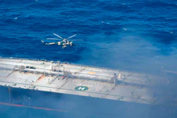 In this photo provided by Sri Lanka Air Force, a chopper flies through smoke rising from the MT New Diamond, off the eastern coast of Sri Lanka in the Indian Ocean,, Saturday, Sept. 5, 2020. The fire on the large oil tanker off Sri Lanka's coast has been brought under control but is still not extinguished, the navy said Saturday. The tanker, carrying nearly 2 million barrels of crude oil, was drifting about 20 nautical miles (37 kilometers) from Sri Lanka's eastern coast and on Friday evening a tug boat towed it to the deep sea away from land, said navy spokesman Capt. Indika de Silva.